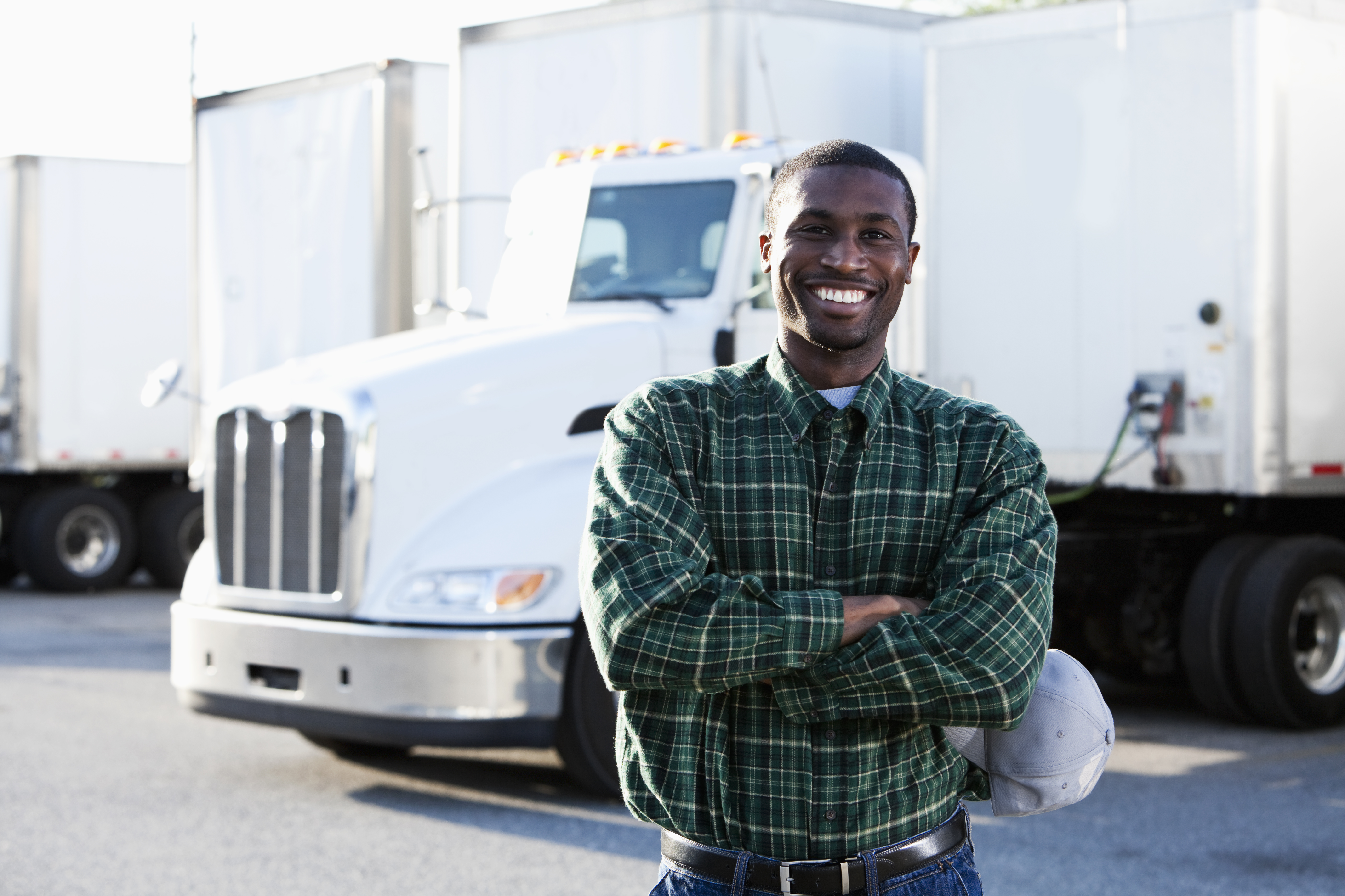 Man standing in front of his semi-truck.