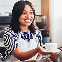 Café worker serving coffee