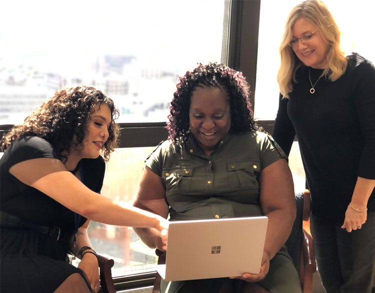 Coworkers around computer