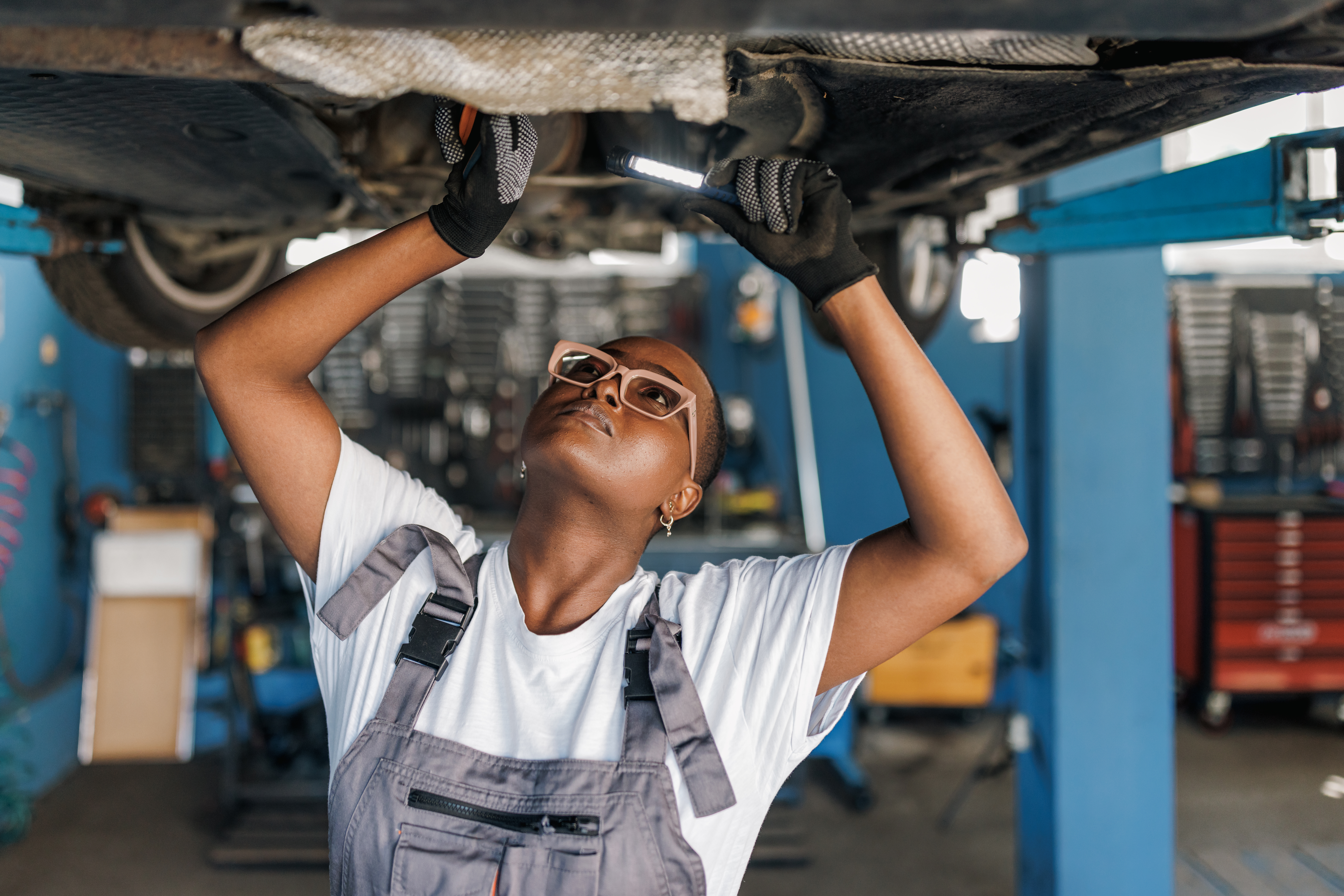 Female mechanic working on a car