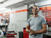 Man stands in front of a wall of tools